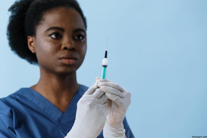 close up shot of a female nurse holding a syringe